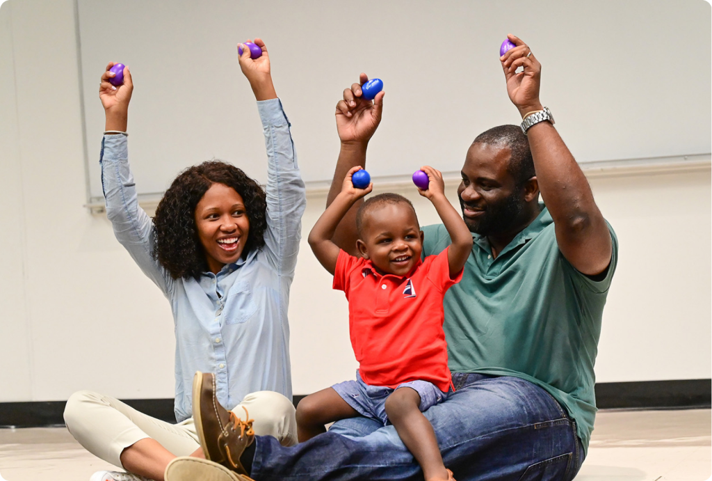 Family playing egg shakers in Music Together class