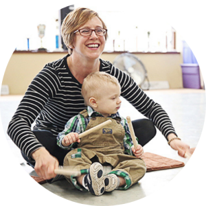 Mom and baby playing rhythm sticks in Music Together class