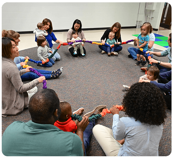 A group of families sitting in a circle at Music Together class