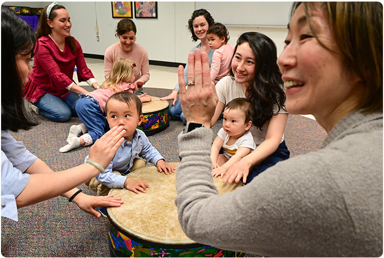 Playing the gathering drum in Music Together class