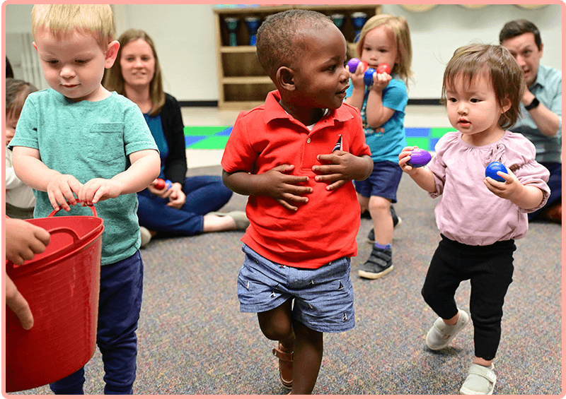 Children with egg shakers dancing