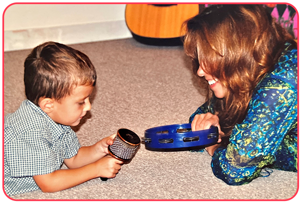 Max as toddler playing music on floor with Mom, Cynthia