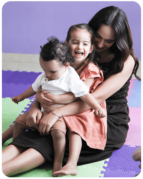 mom with older child and baby sitting in lap