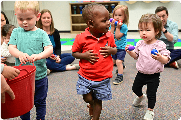 children putting egg shakers away after song